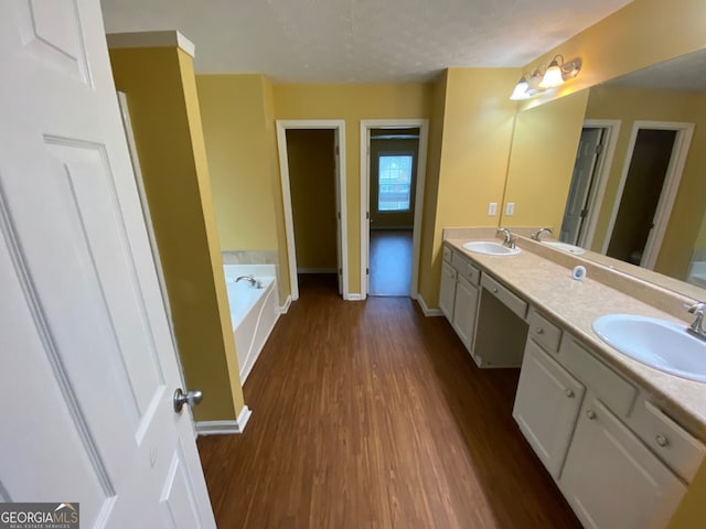 1472 Queenie Smith Rd NE, Conyers, GA 30012 - full bath with wood finished floors, double vanity, and a garden tub