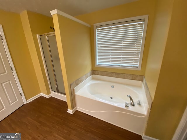 1472 Queenie Smith Rd NE, Conyers, GA 30012 - bathroom with wood finished floors, a shower stall, and a bath
