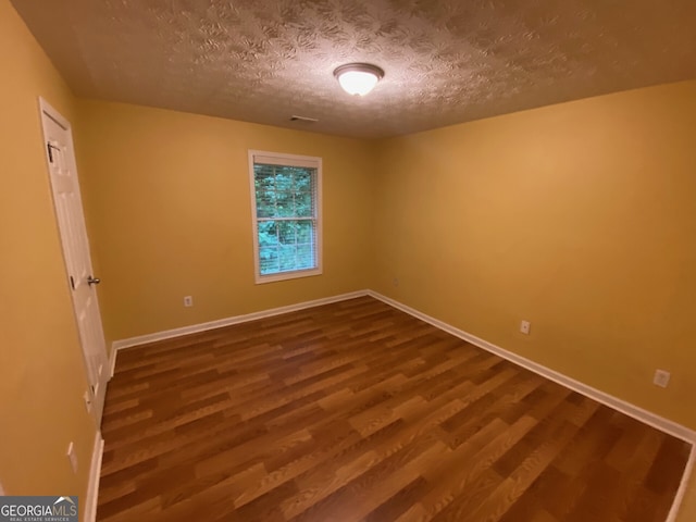1472 Queenie Smith Rd NE, Conyers, GA 30012 - unfurnished room featuring wood finished floors and a textured ceiling