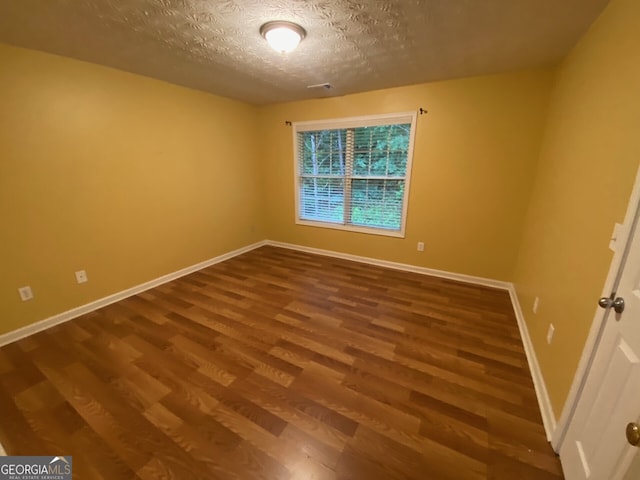 1472 Queenie Smith Rd NE, Conyers, GA 30012 - spare room with wood finished floors and a textured ceiling