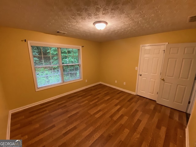 1472 Queenie Smith Rd NE, Conyers, GA 30012 - unfurnished room featuring dark wood-type flooring and a textured ceiling