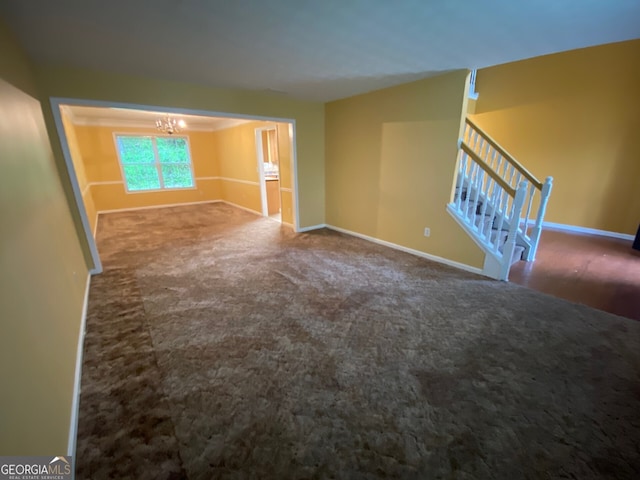 1472 Queenie Smith Rd NE, Conyers, GA 30012 - unfurnished living room featuring a chandelier, carpet floors, and stairs
