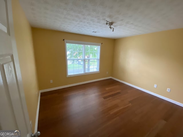 1472 Queenie Smith Rd NE, Conyers, GA 30012 - empty room featuring wood finished floors and a textured ceiling