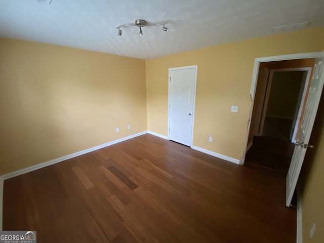 1472 Queenie Smith Rd NE, Conyers, GA 30012 - empty room featuring dark wood-type flooring and baseboards