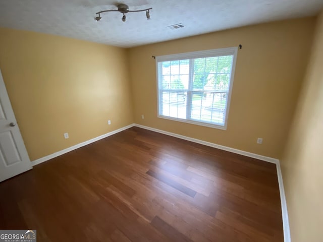 1472 Queenie Smith Rd NE, Conyers, GA 30012 - unfurnished room featuring baseboards and dark wood-style flooring