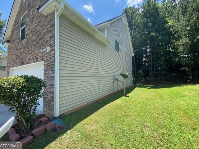 1472 Queenie Smith Rd NE, Conyers, GA 30012 - view of side of property with stone siding, a yard, and an attached garage
