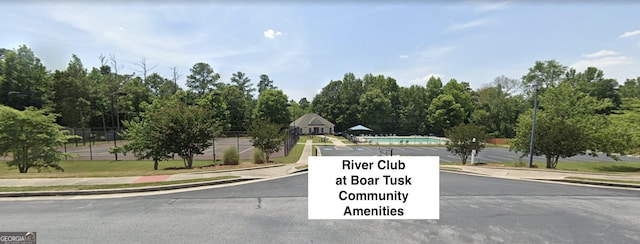 1472 Queenie Smith Rd NE, Conyers, GA 30012 - view of asphalt road featuring sidewalks, street lights, and curbs