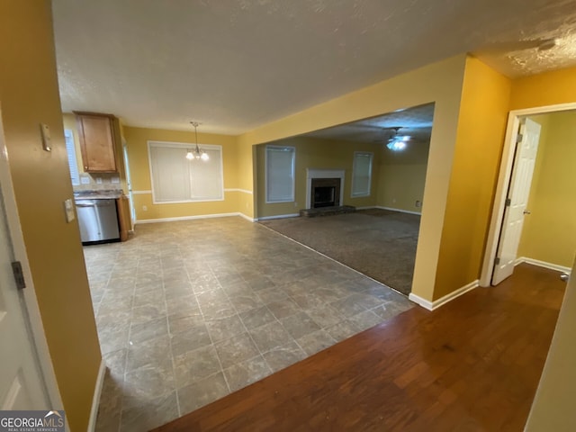 1472 Queenie Smith Rd NE, Conyers, GA 30012 - unfurnished living room featuring a fireplace with raised hearth and a chandelier
