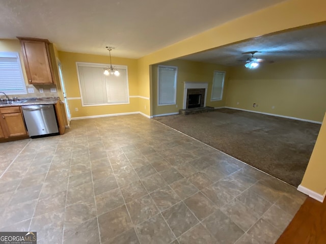 1472 Queenie Smith Rd NE, Conyers, GA 30012 - unfurnished living room with a fireplace with raised hearth, a ceiling fan, light colored carpet, and a chandelier