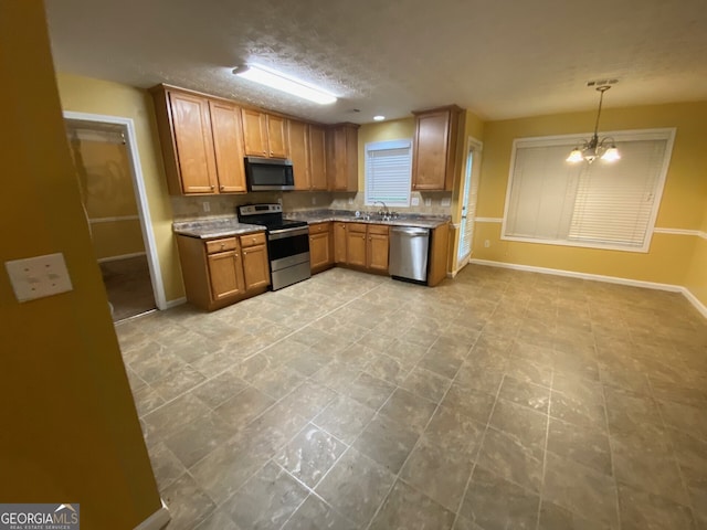 1472 Queenie Smith Rd NE, Conyers, GA 30012 - kitchen featuring stainless steel appliances, brown cabinetry, pendant lighting, and decorative backsplash
