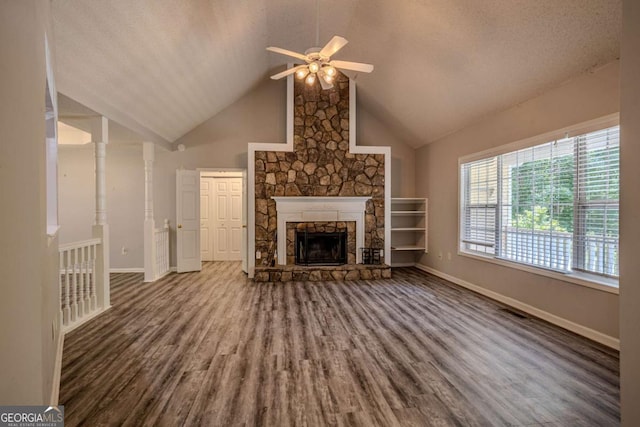 217 Bridgewater Trl, Canton, GA 30115 - unfurnished living room with wood finished floors, a stone fireplace, a ceiling fan, and high vaulted ceiling
