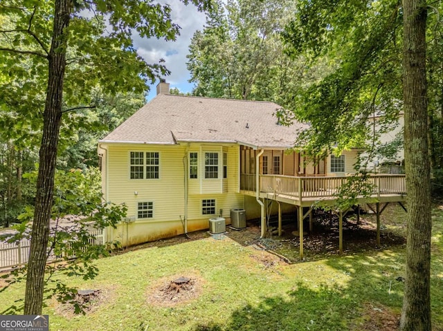 217 Bridgewater Trl, Canton, GA 30115 - back of property featuring a wooden deck, a chimney, a lawn, and roof with shingles