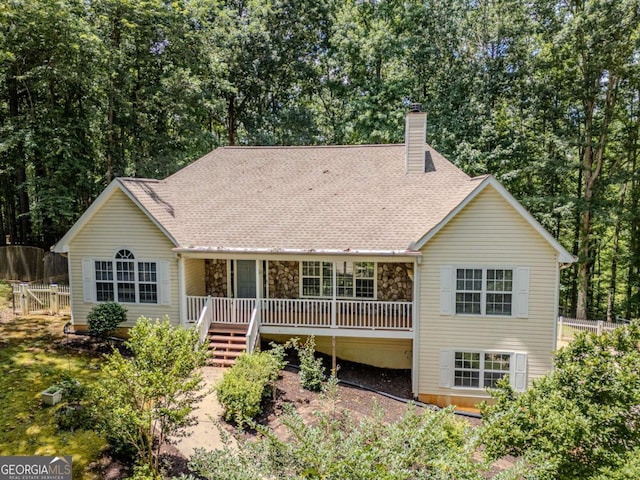 217 Bridgewater Trl, Canton, GA 30115 - back of house with a chimney, a shingled roof, and stone siding