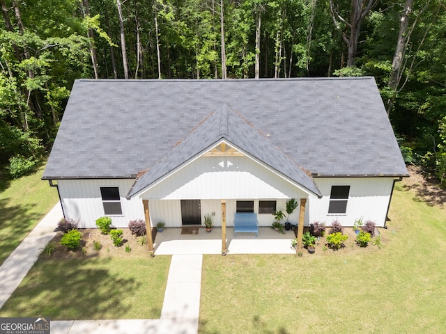 275 Bethlehem Church Rd, Carrollton, GA 30117 - view of front of house with a patio, a front lawn, and a forest view