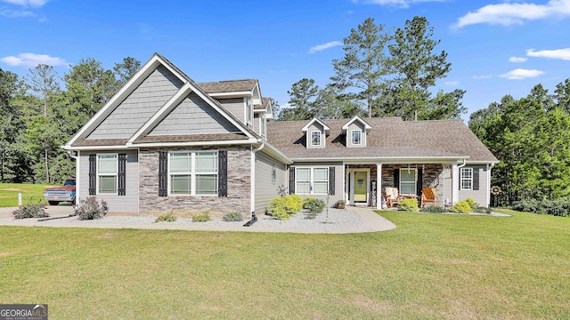 120 Mylee Cv, Barnesville, GA 30204 - view of front of home with stone siding, a front lawn, covered porch, and a shingled roof