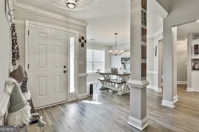 120 Mylee Cv, Barnesville, GA 30204 - entrance foyer featuring a chandelier, crown molding, and wood finished floors