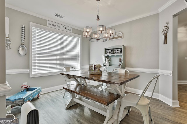 120 Mylee Cv, Barnesville, GA 30204 - dining area with wood finished floors, crown molding, a chandelier, and plenty of natural light