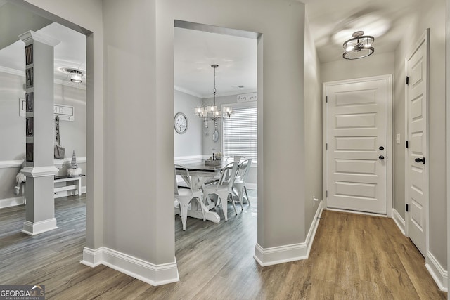 120 Mylee Cv, Barnesville, GA 30204 - foyer featuring wood finished floors, a chandelier, and crown molding