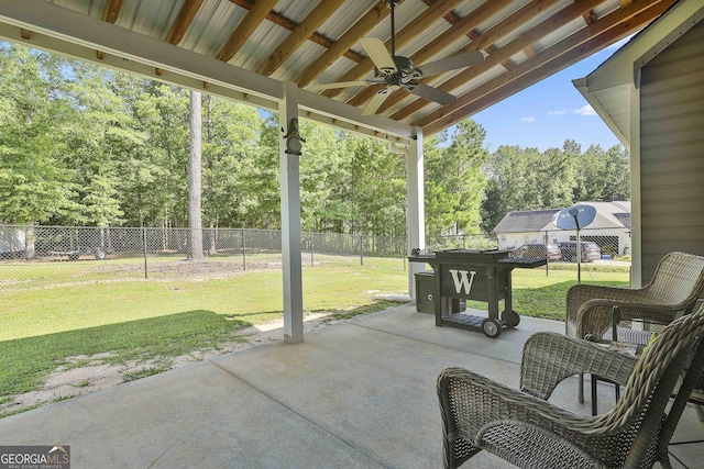 120 Mylee Cv, Barnesville, GA 30204 - fenced backyard with ceiling fan, a patio area, and view of scattered trees