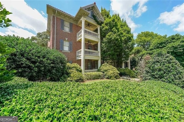 2 Collier Rd NW Unit 5, Atlanta, GA 30309 - back of property with a ceiling fan, a balcony, and brick siding