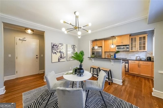 2 Collier Rd NW Unit 5, Atlanta, GA 30309 - dining room featuring a chandelier, dark wood-style flooring, and ornamental molding