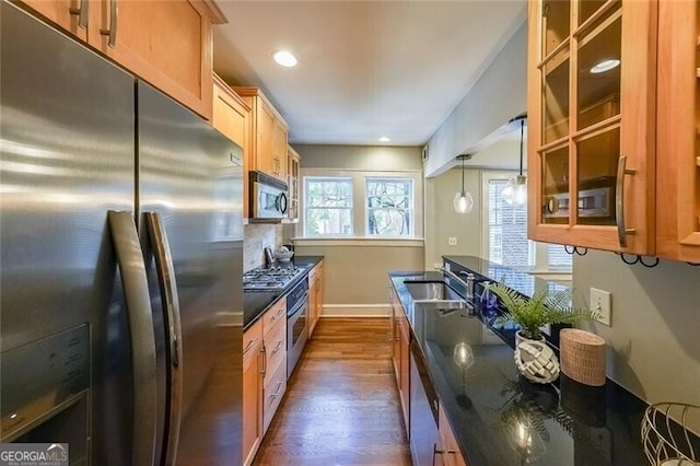 2 Collier Rd NW Unit 5, Atlanta, GA 30309 - kitchen featuring stainless steel appliances, dark countertops, dark wood-style flooring, glass insert cabinets, and tasteful backsplash