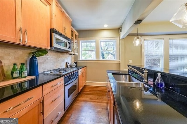 2 Collier Rd NW Unit 5, Atlanta, GA 30309 - kitchen with stainless steel appliances, dark wood finished floors, backsplash, hanging light fixtures, and recessed lighting