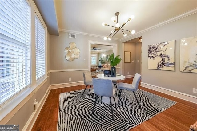 2 Collier Rd NW Unit 5, Atlanta, GA 30309 - dining area with ornamental molding, a chandelier, wood finished floors, and plenty of natural light