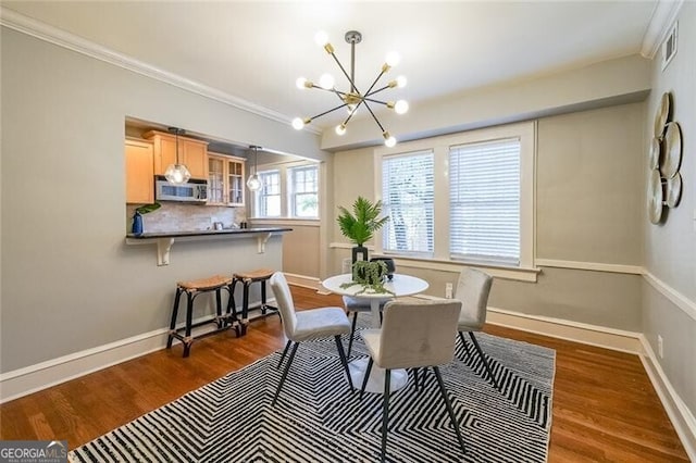 2 Collier Rd NW Unit 5, Atlanta, GA 30309 - dining space with a chandelier, wood finished floors, and ornamental molding