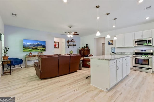 286 Kimberleys Xing, Jasper, GA 30143 - kitchen featuring stainless steel appliances, open floor plan, light wood-type flooring, white cabinets, and recessed lighting