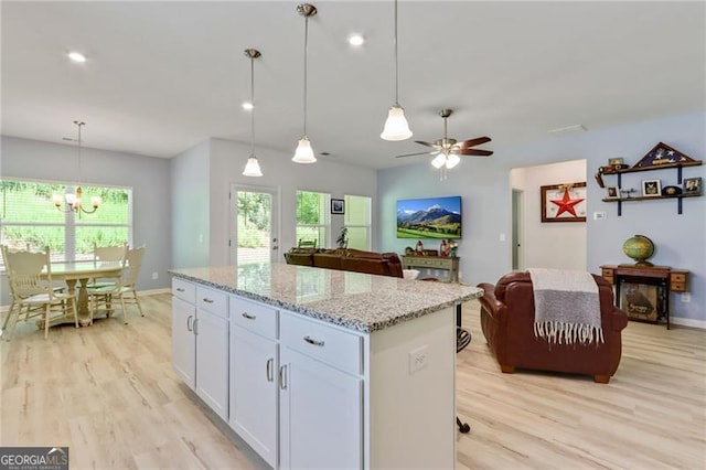 286 Kimberleys Xing, Jasper, GA 30143 - kitchen featuring light wood finished floors, a kitchen island, light stone countertops, hanging light fixtures, and recessed lighting