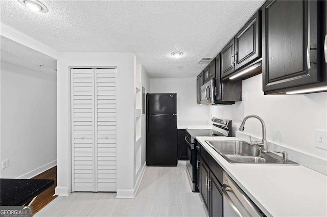 383 Ralph Mcgill Blvd NE Unit J, Atlanta, GA 30312 - kitchen featuring appliances with stainless steel finishes, light countertops, and a textured ceiling