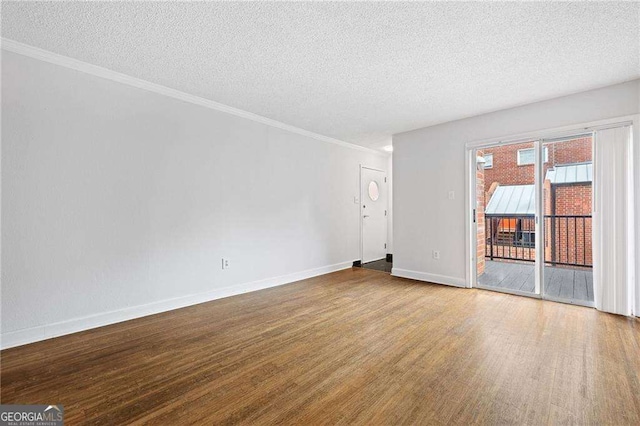 383 Ralph Mcgill Blvd NE Unit J, Atlanta, GA 30312 - empty room featuring wood finished floors, a textured ceiling, and crown molding
