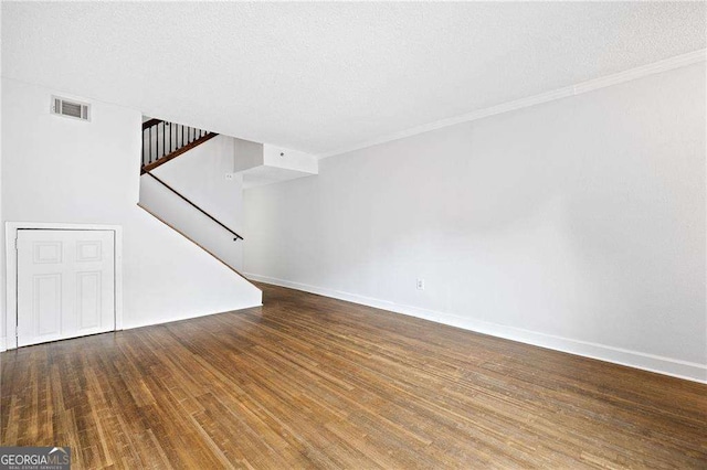 383 Ralph Mcgill Blvd NE Unit J, Atlanta, GA 30312 - unfurnished living room with wood finished floors, stairs, crown molding, and a textured ceiling