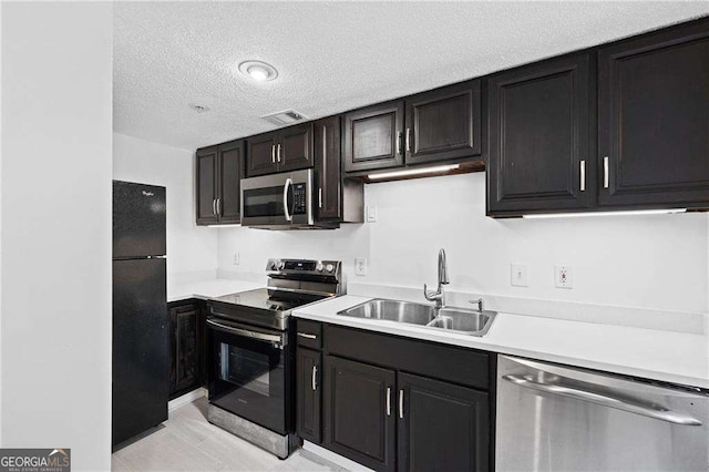 383 Ralph Mcgill Blvd NE Unit J, Atlanta, GA 30312 - kitchen featuring stainless steel appliances, light countertops, a textured ceiling, and dark cabinets