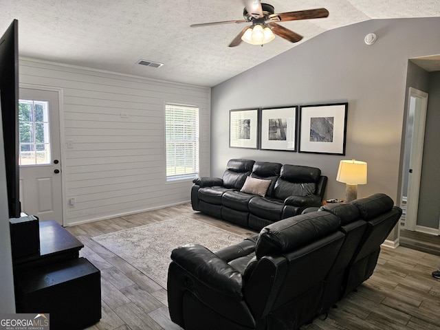 100 Lexington Pl, Senoia, GA 30276 - living area featuring vaulted ceiling, a ceiling fan, a textured ceiling, and wood finished floors