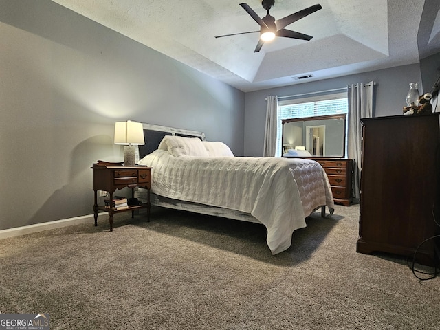 100 Lexington Pl, Senoia, GA 30276 - carpeted bedroom featuring a raised ceiling, a textured ceiling, and a ceiling fan
