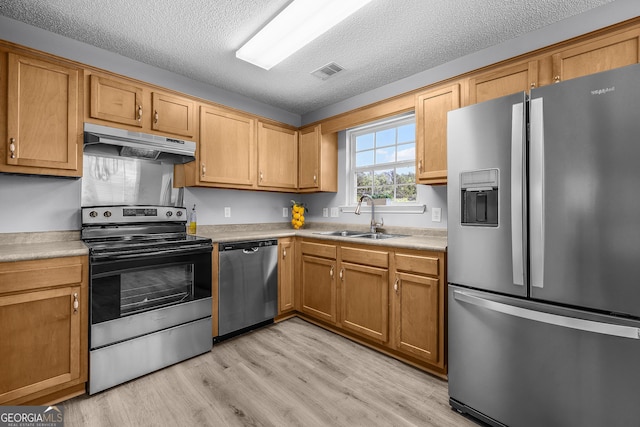 7 Springwater Dr, Port Wentworth, GA 31407 - kitchen featuring stainless steel appliances, under cabinet range hood, light countertops, light wood-type flooring, and a textured ceiling