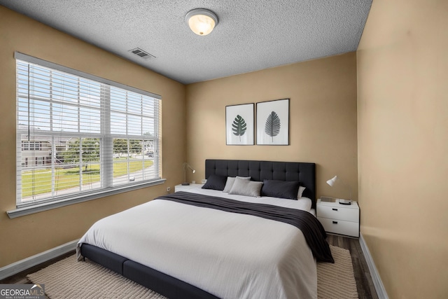 7 Springwater Dr, Port Wentworth, GA 31407 - bedroom featuring multiple windows, wood finished floors, and a textured ceiling