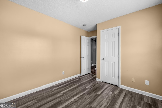 7 Springwater Dr, Port Wentworth, GA 31407 - unfurnished bedroom featuring dark wood-type flooring and a textured ceiling