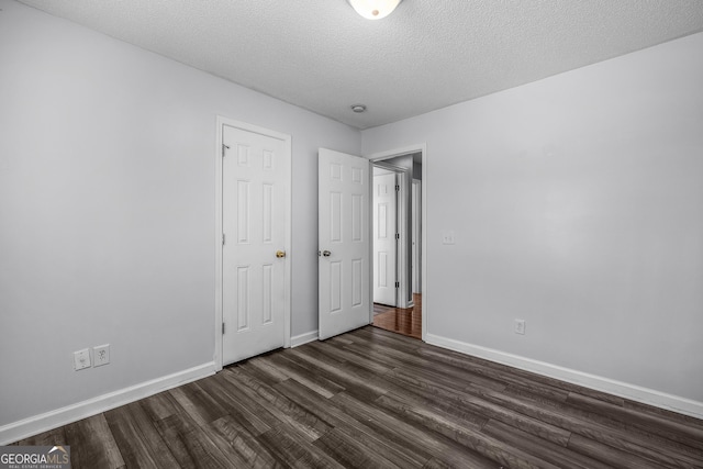 7 Springwater Dr, Port Wentworth, GA 31407 - unfurnished bedroom with dark wood finished floors and a textured ceiling