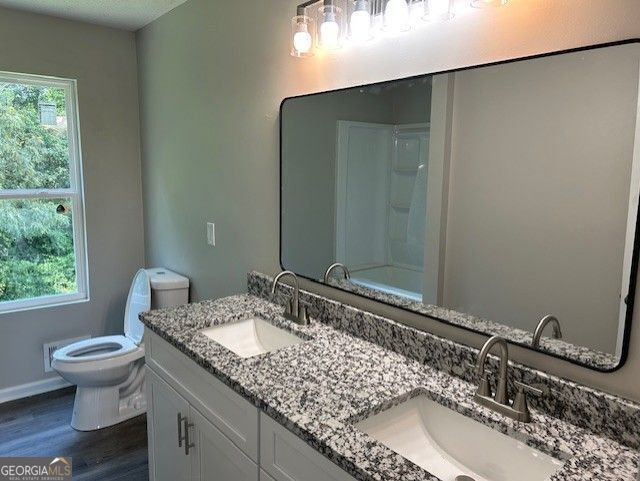 433 Rhett Dr, Loganville, GA 30052 - full bath with wood finished floors and double vanity