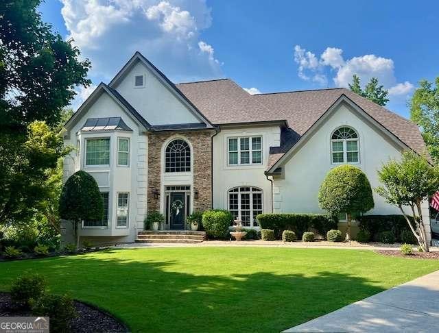 5085 Johns Creek Ct, Johns Creek, GA 30022 - view of front of property featuring stone siding, stucco siding, and a front lawn