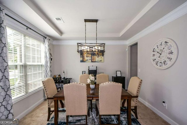 325 Paces Dr, Lithia Springs, GA 30122 - dining space featuring a tray ceiling, a chandelier, light carpet, and ornamental molding