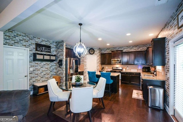 325 Paces Dr, Lithia Springs, GA 30122 - dining space featuring brick wall, dark wood-style floors, and recessed lighting
