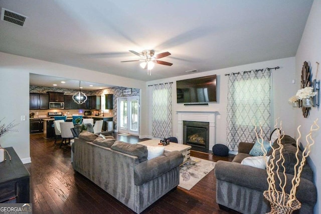 325 Paces Dr, Lithia Springs, GA 30122 - living room featuring dark wood-style floors, ceiling fan, and a glass covered fireplace
