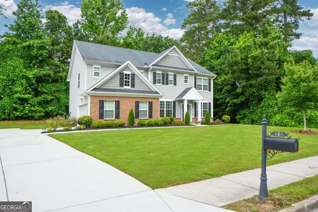 325 Paces Dr, Lithia Springs, GA 30122 - view of front facade with brick siding, a front lawn, an attached garage, and driveway