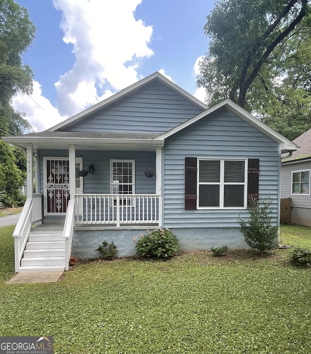 1833 Phillips Ave, East Point, GA 30344 - bungalow featuring a front yard and covered porch