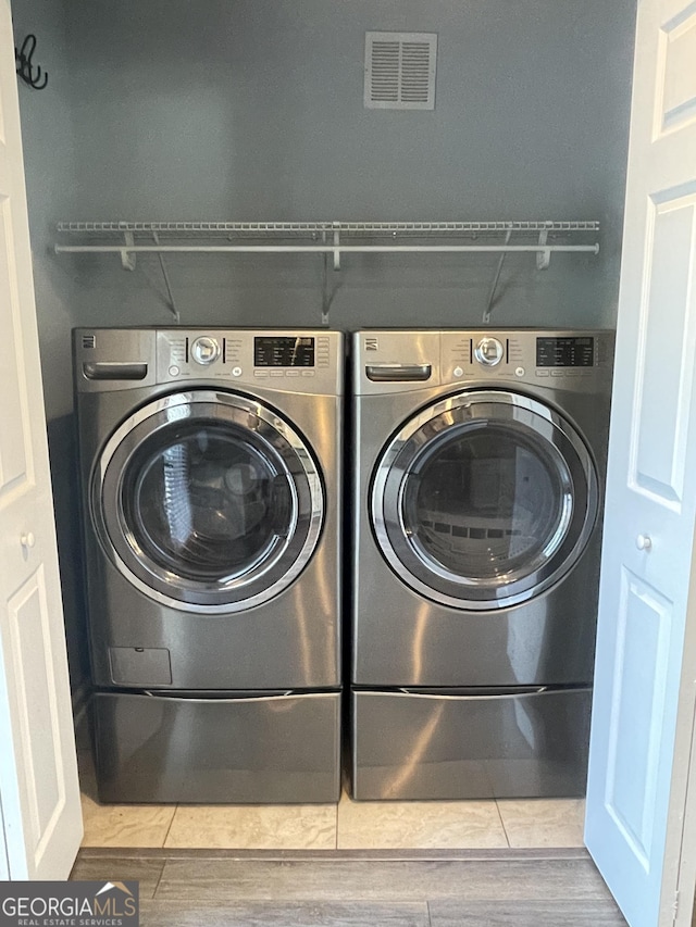 1833 Phillips Ave, East Point, GA 30344 - laundry room featuring washing machine and clothes dryer and wood finished floors