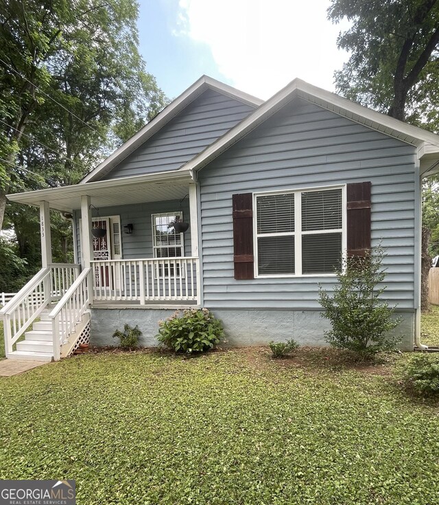 1833 Phillips Ave, East Point, GA 30344 - bungalow with a porch and a front lawn